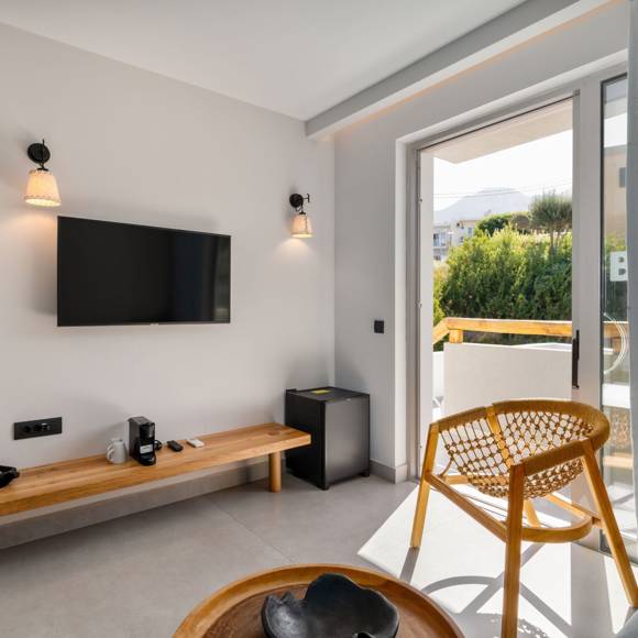 Maisonette suite living area with TV, wooden furniture and access to a private outdoor area