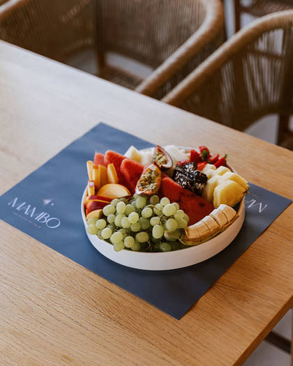 Colorful fresh fruit platter with grapes, bananas, watermelon and seasonal fruits 