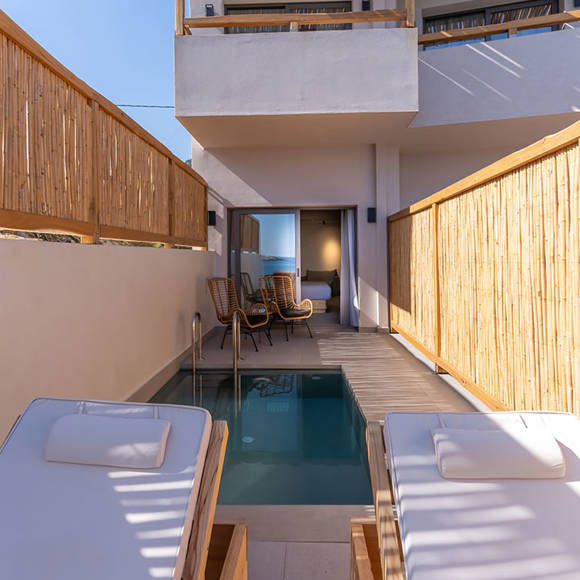 Junior suite outdoor private pool area, a pair of sun loungers, a shaded sitting area, and bamboo fencing for privacy
