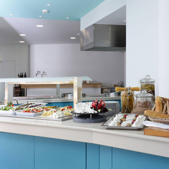 Buffet area of the main restaurant with a variety of fresh breads, cheeses, fruits and appetizers