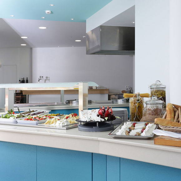 Buffet area of the main restaurant with a variety of fresh breads, cheeses, fruits and appetizers
