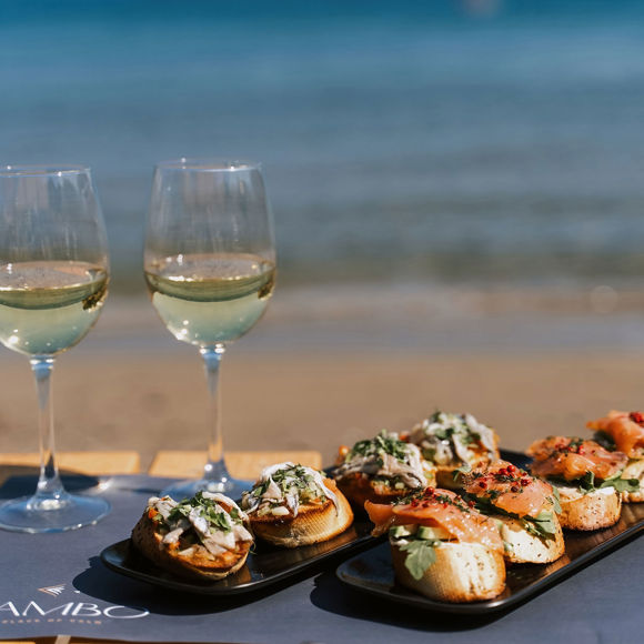 Seafood appetizers and white wine served beachside at Mambo Beach Restaurant