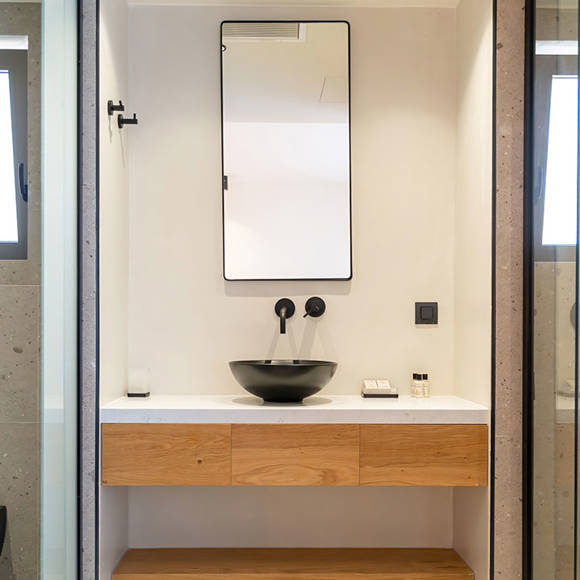 Suite bathroom vanity with black vessel sink, large mirror and wooden cabinetry