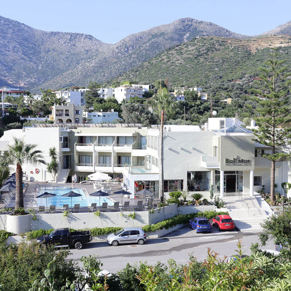 Panoramic exterior view of Bali Star Hotel with surrounding mountains, garden areas and swimming pool